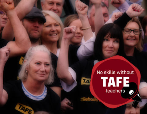 TAFE members raise hands in solidarity