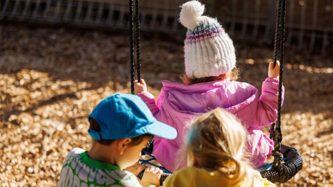 three children swing childcare