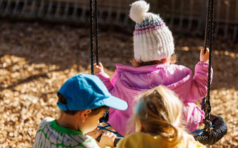 three children swing childcare