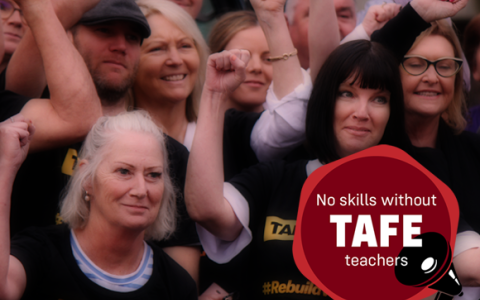 TAFE members raise hands in solidarity